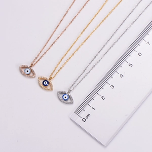 Macro detail of evil eye necklace pendants in gold, silver and rose gold finishes