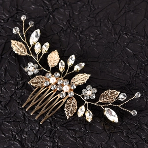 Handmade silver leaf hair comb with pearls and rhinestones on black background