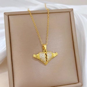 Macro shot of gold-plated broken heart pendant with clear zircon stones on a chain