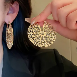Chic hollow circular gold earrings with vintage lace-style geometric metal design