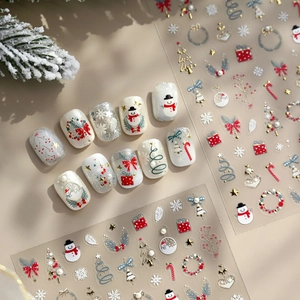 Luxurious Christmas nail stickers with 3D gold embossed trees, bells, and holiday stars