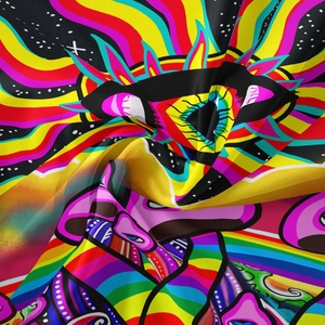 Detail of psychedelic mushroom tapestry fabric with colorful rainbow eyes and star patterns
