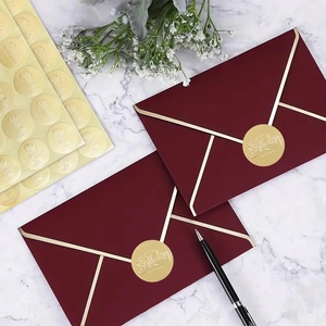 Burgundy envelope with gold Happy Birthday foil sticker on marble background
