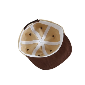 Internal view of baby color-block baseball cap showing breathable holes and reinforcement tape