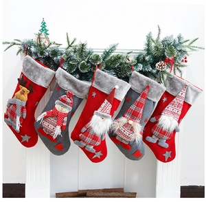 Five large festive Christmas stockings hanging on a fireplace with plush fur trim