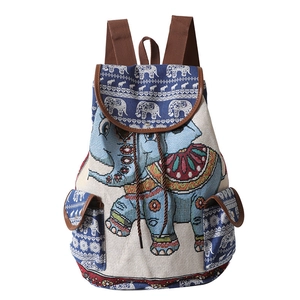 Ethnic blue backpack with elephant pattern showing woven texture and leather trim details