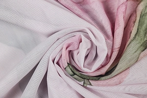 Macro shot of breathable floral mesh fabric with gradient pink and green hues