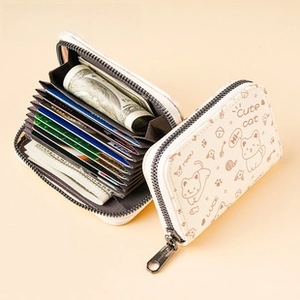 Macro view of white quilted cardholder with cat pattern and accordion slots