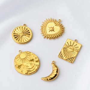 Detail of gold-plated stainless steel sun, moon, and star pendants for DIY jewelry making