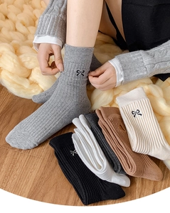 Detail of cotton crew socks with black bow embroidery and ribbed texture in multi-color set