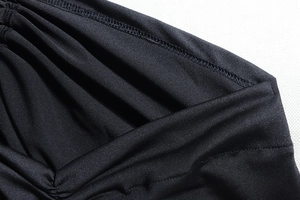Macro detail of black ruched fabric with premium stitching and high elasticity texture
