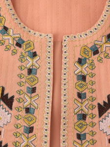 Detail of pink cotton vest featuring colorful ethnic geometric and floral embroidery
