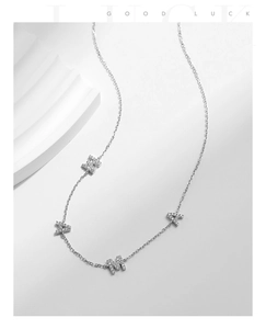 Detail shot of silver S925 MAMA necklace with shimmering pavé diamond letter pendants