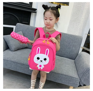 Detailed view of pink children school bag with cute white rabbit print and matching pencil case