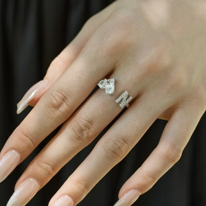 Close-up of S925 sterling silver open ring with heart zircon and letter N on finger
