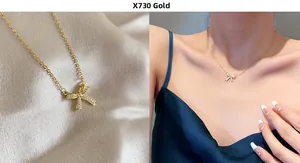 Detail of gold bow necklace with sparkling crystals shown on fabric and on model