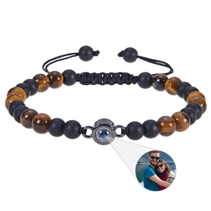 Projection bracelet featuring black matte beads and tiger eye stones with custom photo inside