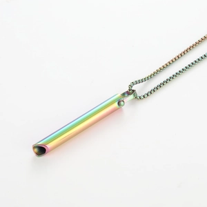 Detailed macro shot of a rainbow stainless steel mindfulness pendant with hollow tube design