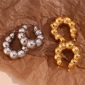 Detail of hollow cloud bubble hoop earrings in polished gold and silver finishes