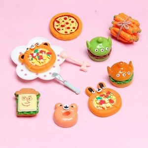 Close-up of miniature resin food charms including pizza, burger, and sandwiches