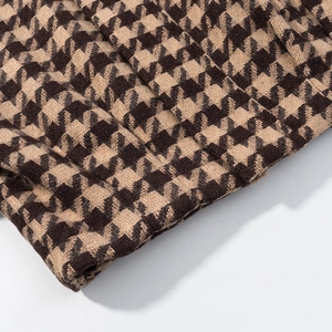 Macro shot of brown and beige houndstooth wool fabric texture for retro women's suit set