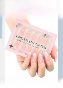 Macro view of pink press-on nails with white French tips and elegant gift box packaging