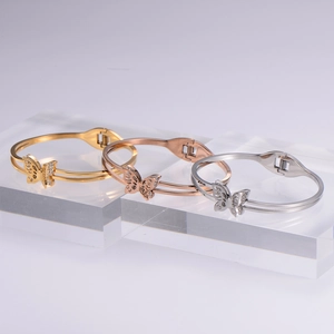 Three minimalist butterfly open bangles in gold, rose gold and silver finishes with zircons
