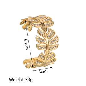 Detailed view of gold feather open bangle with zircon inlay, size 6.1cm by 3cm, weighing 28g
