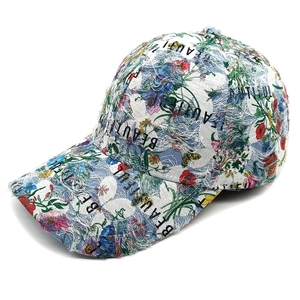 Ethnic denim baseball cap with floral print and distressed ripped details in blue finish