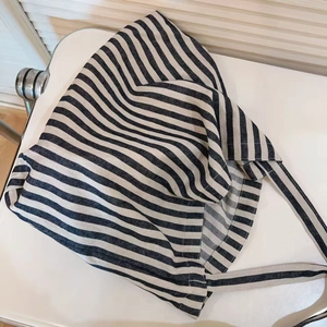 Detail of blue and white striped canvas tote bag showing soft cotton fabric texture