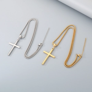 Detail of silver and gold stainless steel cross necklaces with adjustable pearl chains