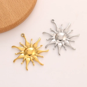 Close-up of vintage sun-shaped stainless steel flower pendants in gold and silver
