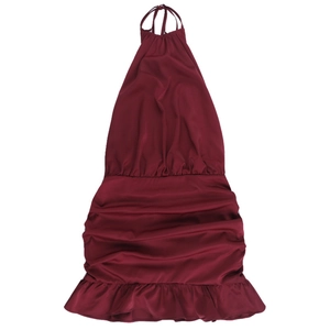 Detail of burgundy satin dress showing ruched fabric texture and halter neck design