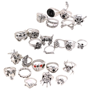 Gothic punk vintage silver ring set with skull and spider elements on white background