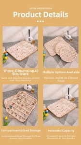 Detailed macro view of beige velvet jewelry display tray with wooden frame and slots