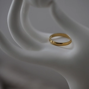 Detail of minimalist 18K gold plated celestial ring on a white mannequin hand