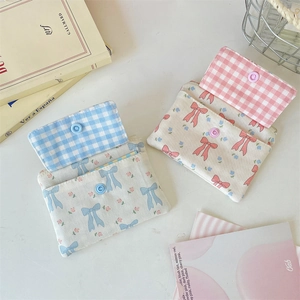 Close-up of floral canvas card pouches with secure snap closure and thick fabric texture