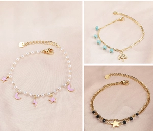 Detail of stainless steel bracelets with pearls, colorful charms and enamel pendants