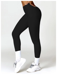 Detailed side view of high-waisted black yoga leggings with moisture-wicking fabric