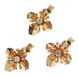 Three elegant golden metal flower hair clips with sparkling crystal centers for girls