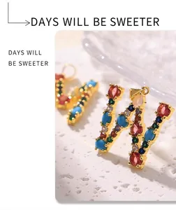 Detailed view of letter W pendant with colorful zircons in a gold plated setting