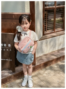 Pink crossbody bag for kids featuring cartoon polar bear and cactus patch decorations