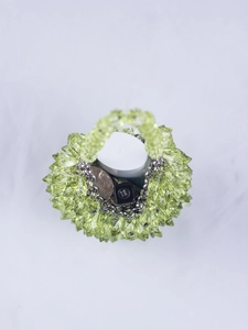 Detail of neon green beaded handbag showing acrylic spikes and silver chain handle