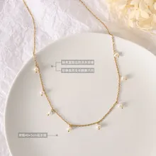 Detail view of gold Cuban chain necklace with natural freshwater pearls and extender