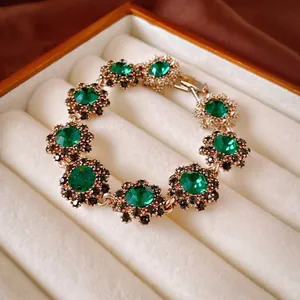 Bracciale vintage dorato con fiori in pietre verde smeraldo e cristalli neri eleganti