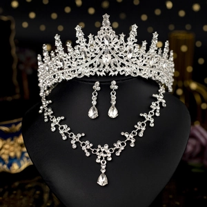 Close-up of sparkling bridal jewelry set with tiara, necklace and drop earrings