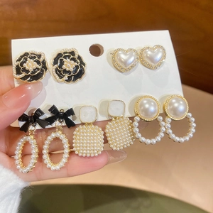 Detail of vintage French style flower and pearl earring set with gold-plated finish