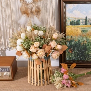 Rustic floral arrangement with white and champagne roses in a bamboo style vase