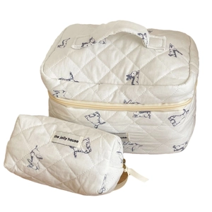 Quilted white cosmetic bag set with blue bunny patterns and top handle for travel