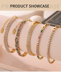 Close-up of stacked gold tennis bracelets with colorful zircon stones on a display